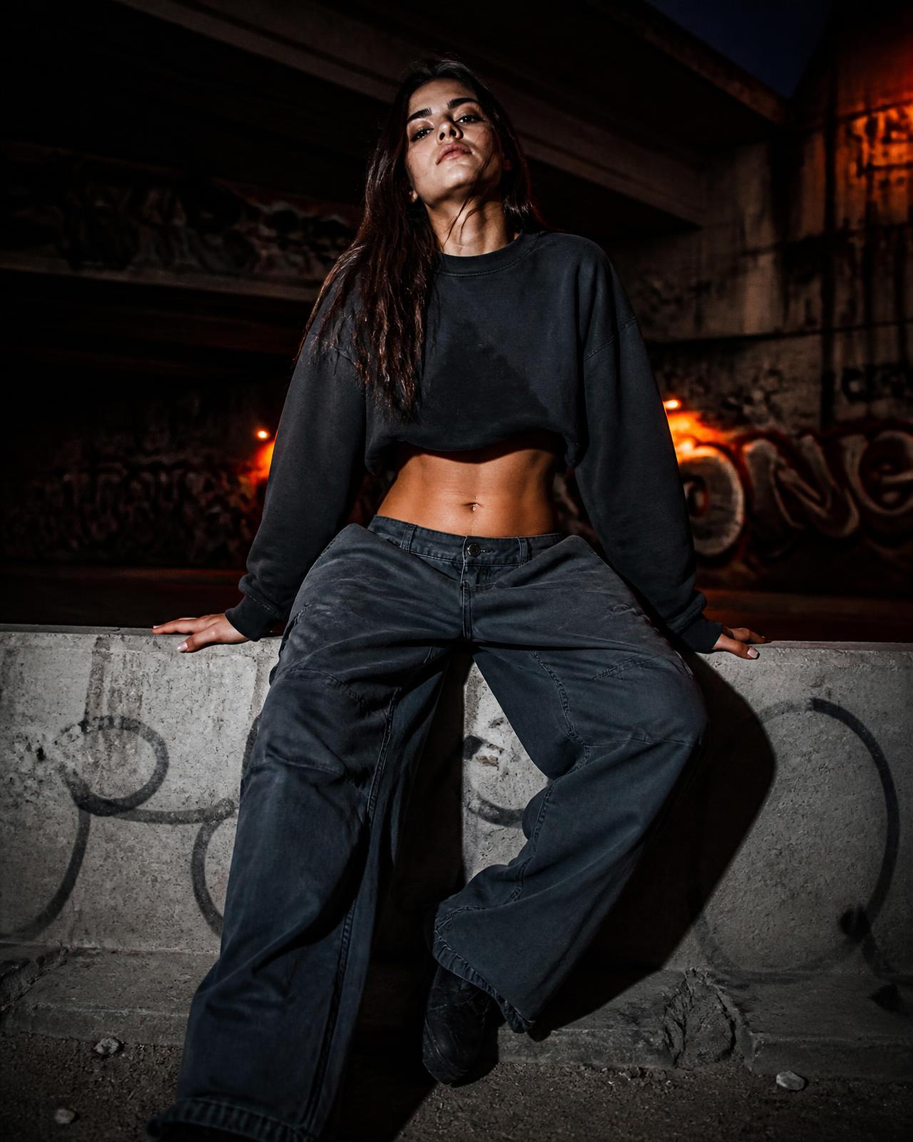 REZELION sweatshirt worn under a graffiti-covered underpass